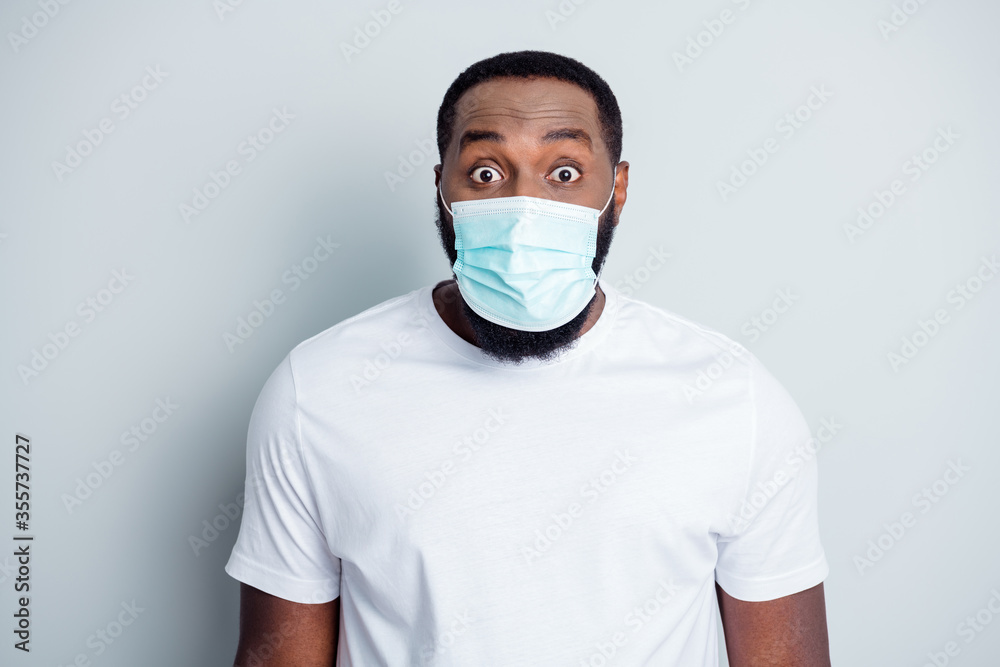 Photo of crazy terrified dark skin african guy protester community protest demonstration lawlessness see police frightened guns wear t-shirt facial mask isolated grey color background