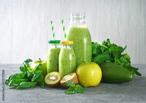 Green smoothie with organic green fruits, spinach and mint. Detox juice. Tasty diet concept.