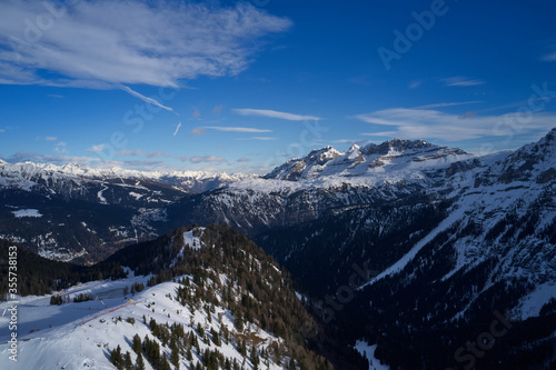 Panoramic aerial view of Brenta Dolomites, snow on the slopes of the Alps Madonna di Campiglio, Pinzolo, Italy. The most popular, ski resorts in Italy. Aerial photography with drone. Ski slopes