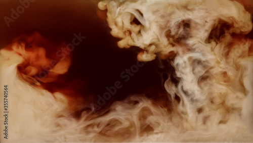 Closeup process of making latte, cappuccino, pouring milk, cream into transparent glass cup with coffee. Abstract brown background with light stains. Mixing of liquids. Hot caffeine drinks concept.