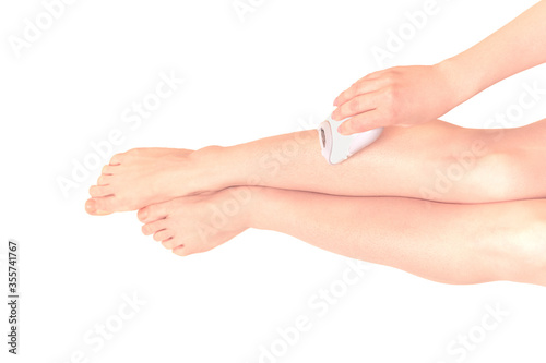Depilation. Woman epilates her leg. woman shaving her legs with electric shaver depilation. isolated on white background