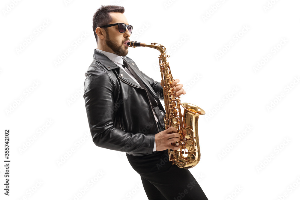 Fototapeta premium Male musician in a leather jacket playing a saxophone