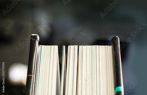 Hard cover book slightly open showing pages close up.