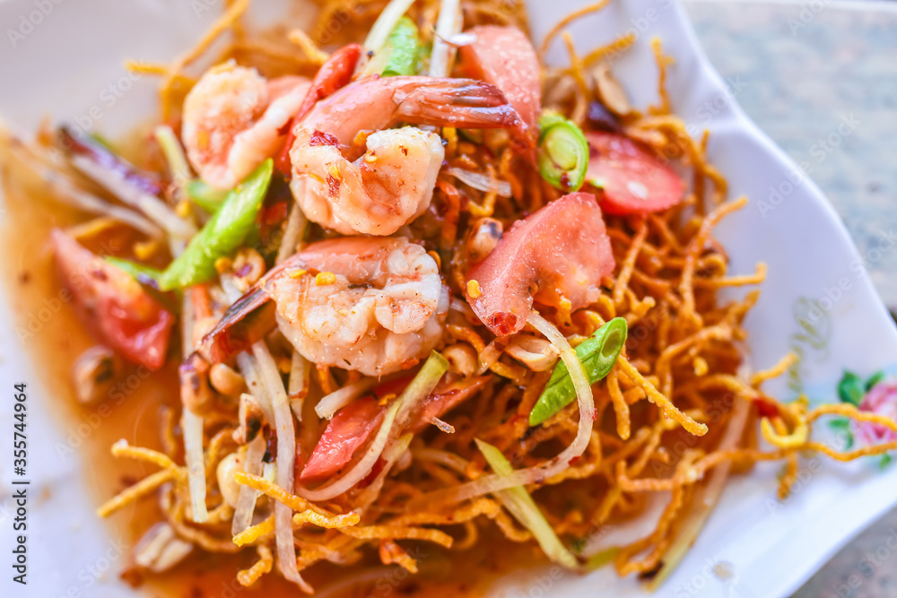 A twist on traditional salads, Fried Papaya Salad..Deep fried papaya with shrimp serve with Thai style sauce.Thai food - green papaya salad with mixed dried shrimp or dried salted prawn (som tum thai) A twist on traditional salads, Fried Papaya Salad..Deep fried papaya with shrimp serve with Thai style sauce.Thai food - green papaya salad with mixed dried shrimp or dried salted prawn (som tum thai)