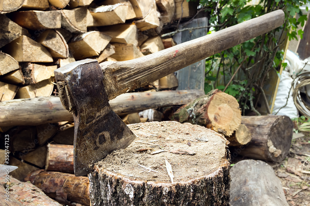 ax, hatchet, axe. split a log with an ax. the brow in the background ax, hatchet, axe. split a log with an ax. the brow in the background