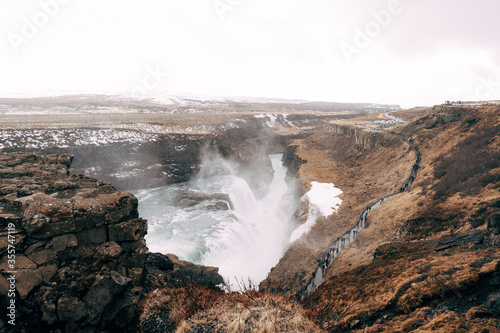 The Great Waterfall Gullfoss in southern Iceland, on the golden ring. Tourists walk on a footpath.