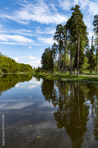 Lake in the forest with the reflection of trees in water © Михаил Макаренко