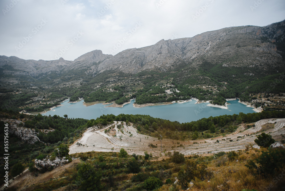 Fototapeta premium Beautiful summer mountain lake view and sunshine in sky. Photography of a Beautiful natural vacation hiking walking travel