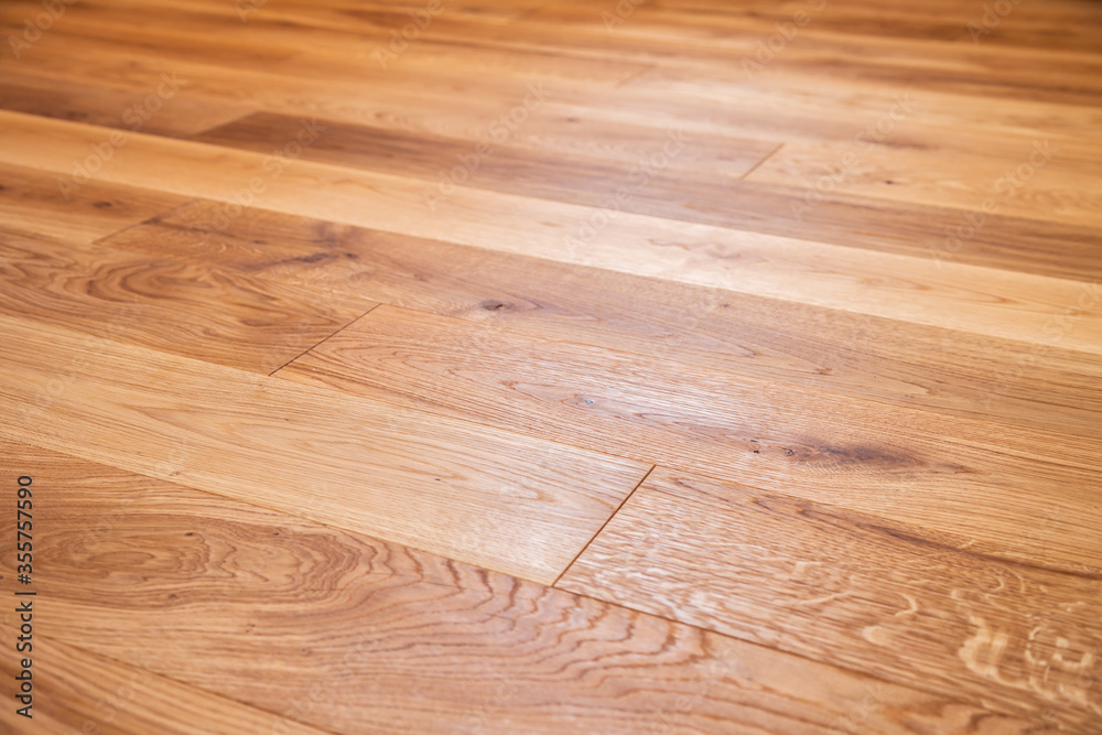 Luxury oak parquet flooring after the application of oil-based floor finish, which tends to enhance the appearance of parquet - obrazy, fototapety, plakaty 