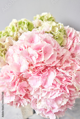 Beautiful pink hydrangea flowers in a vase on a table . Bouquet of light pink flower. Decoration of home. Wallpaper and background.
