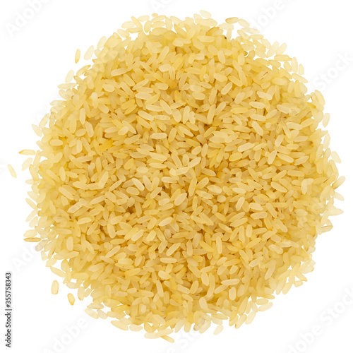 Top view of a heap of raw parboiled rice isolated on white background