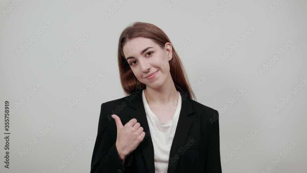 Hand pointer with forefinger pointing aside. Index finger to show direction. Means choosing, introducing too. Indicating towards. Young attractive woman with brown hair in a light t-shirt Hand pointer with forefinger pointing aside. Index finger to show direction. Means choosing, introducing too. Indicating towards. Young attractive woman with brown hair in a light t-shirt