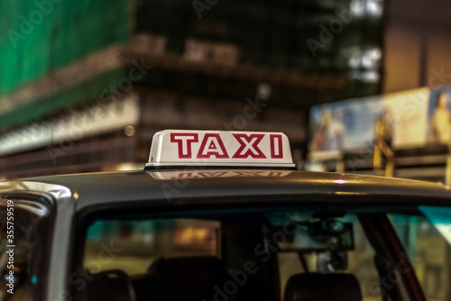 Closeup of a taxi sign at night at Hong Kong