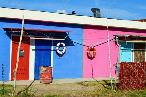 small colorful fisherman houses on the beach in the tourist resort of Vada in the municipality of Rosignano Marittimo in the province of Livorno in Tuscany, Italy photo