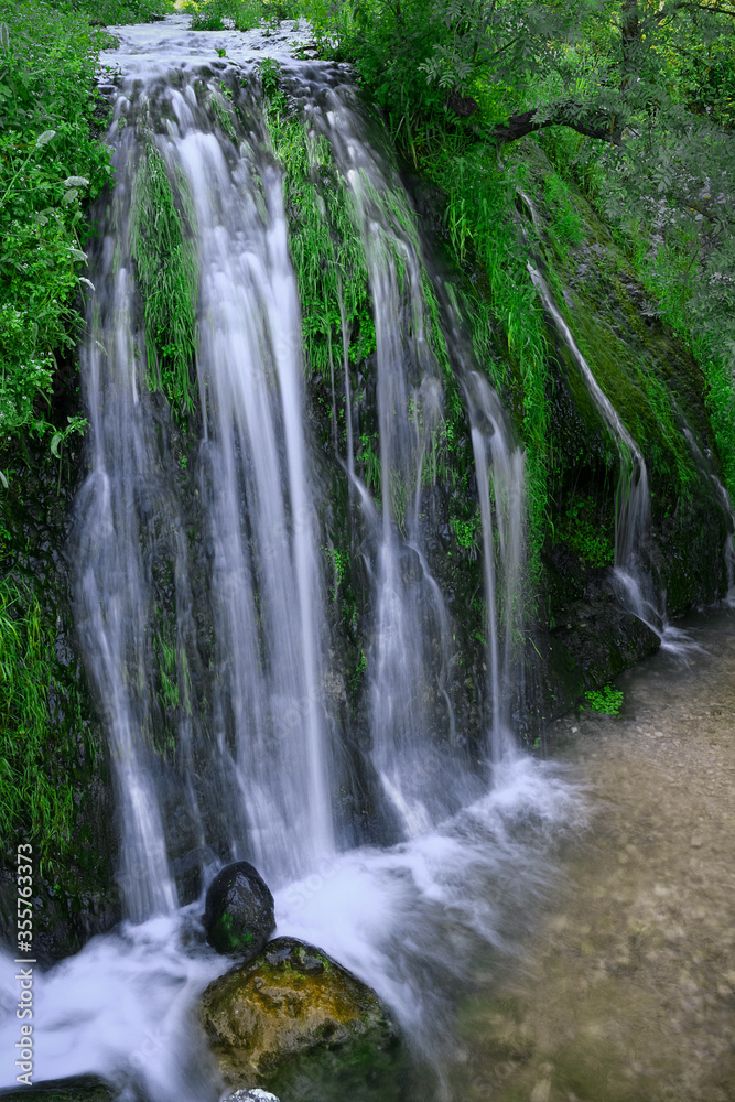 Long cascades of natural water amid vegetation