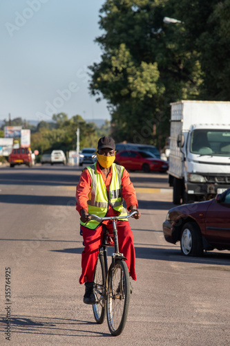 Wallpaper Mural Old African worker dressed with a vest riding a bike Torontodigital.ca