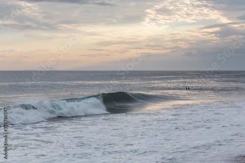 wave washing ashore at sunset