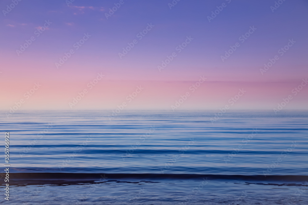 Beautiful light sunset over Baltic sea. Natural background. Latvia. Afterglow, evening calm on the Sea