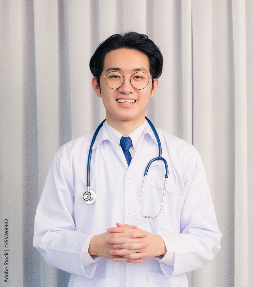 Portrait of Happy Asian young doctor handsome man smiling in uniform with stethoscope talking online video conference call or facetime looking to camera, healthcare medicine concept Portrait of Happy Asian young doctor handsome man smiling in uniform with stethoscope talking online video conference call or facetime looking to camera, healthcare medicine concept