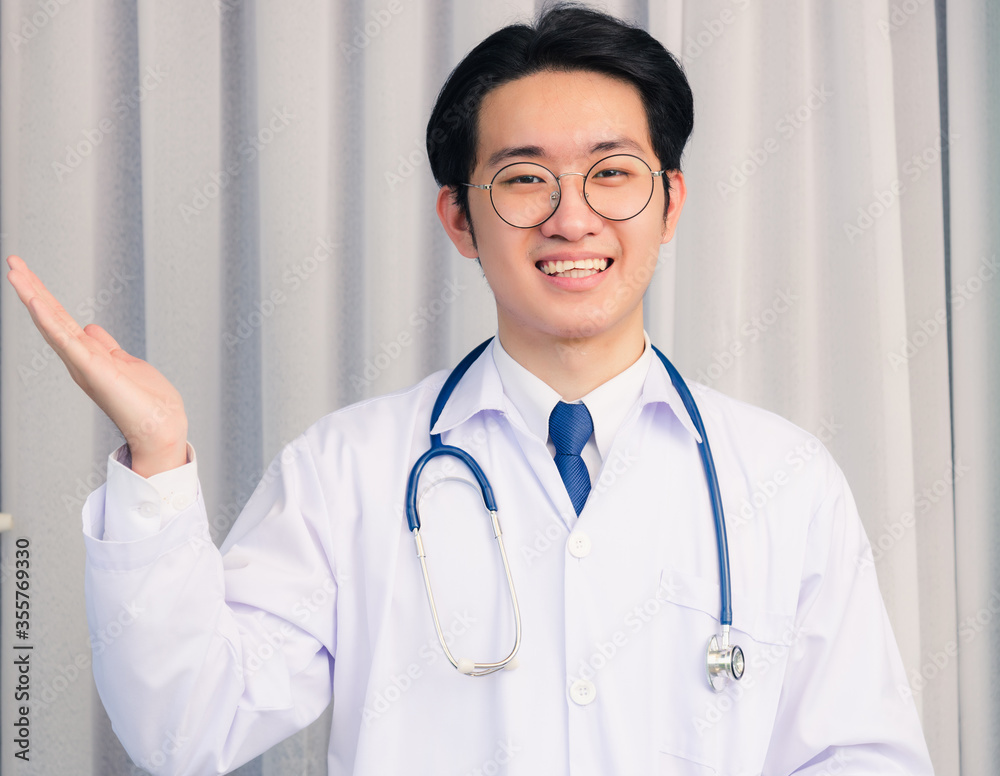 Portrait closeup of Happy Asian young doctor handsome man smiling in uniform and stethoscope neck strap show up hands and looking to the camera with copy space, healthcare medicine concept Portrait closeup of Happy Asian young doctor handsome man smiling in uniform and stethoscope neck strap show up hands and looking to the camera with copy space, healthcare medicine concept