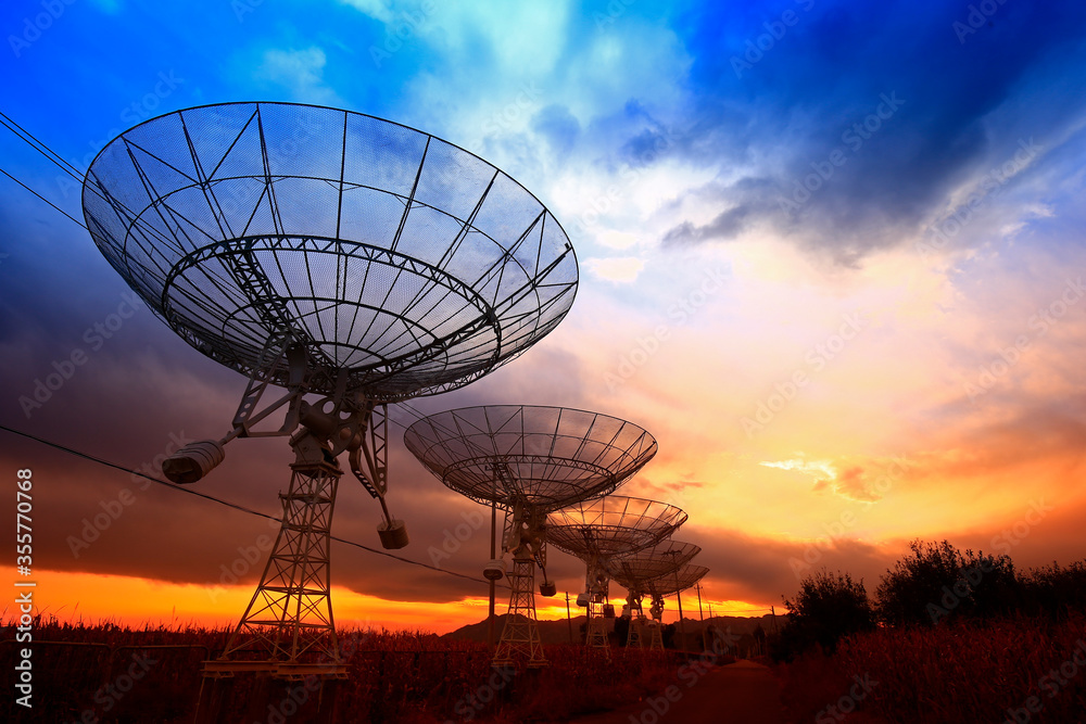 The silhouette of a radio telescope observatory