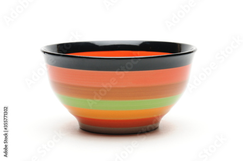 Ceramic bowl with colored stripes on a white background