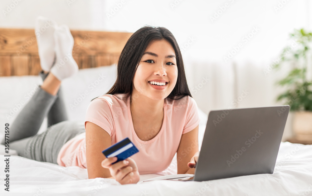 Chinese Girl Holding Credit Card Using Laptop Shopping At Home Chinese Girl Holding Credit Card Using Laptop Shopping At Home