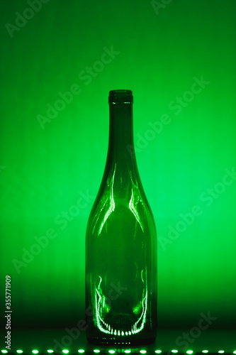 abstract empty wine bottle with green illumination