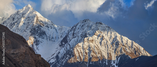 Snow-capped peaks of the Hindu-Kush Mountains. Wakhan Corridor, on the border of Tajikistan and Afghanistan. Travels in Asia. Panorama landscape. photo