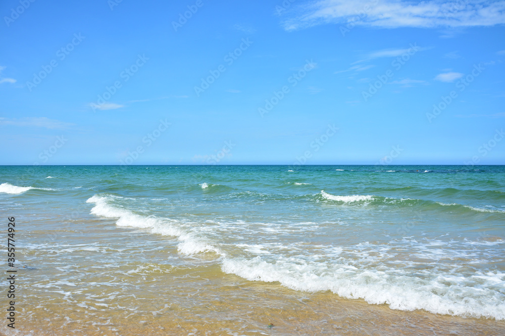 Waves run on the ocean under blue sky