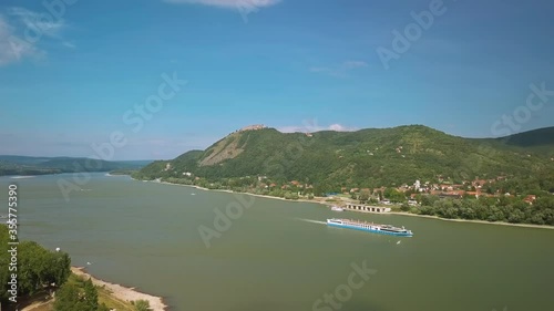 Aerial drone view in the turn of the river Danube in Hungary over Nagymaros. Visegrad castle hiull in the background photo