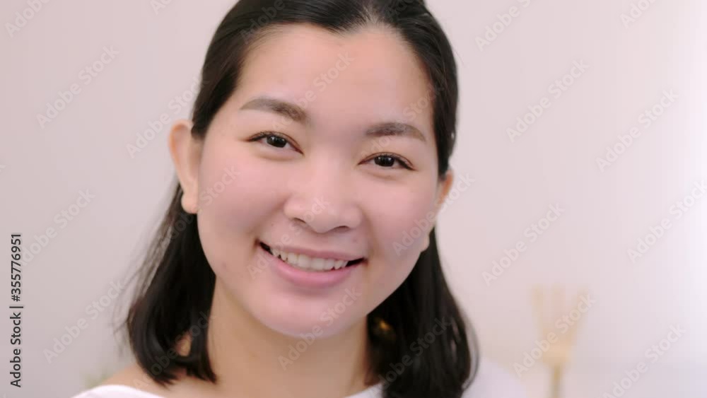Asian women beautiful and smiling are extremely confident young face looking at camera posing alone professional portrait on holiday time and relax with clear light, scene of slow motion.4K 23.97fps Asian women beautiful and smiling are extremely confident young face looking at camera posing alone professional portrait on holiday time and relax with clear light, scene of slow motion.4K 23.97fps