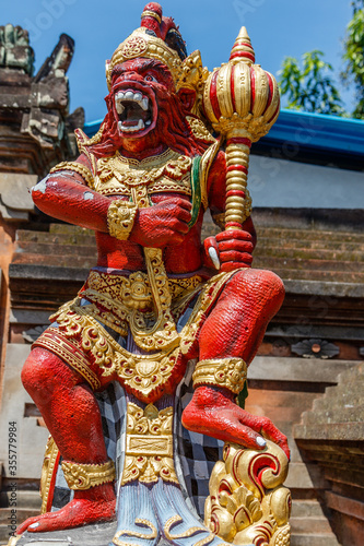 Statue of Vaali (Vali, Bali), divine monkey (vanara) companion of the god Rama, holding gada (mace). Bali, Indonesia. Vertical image.