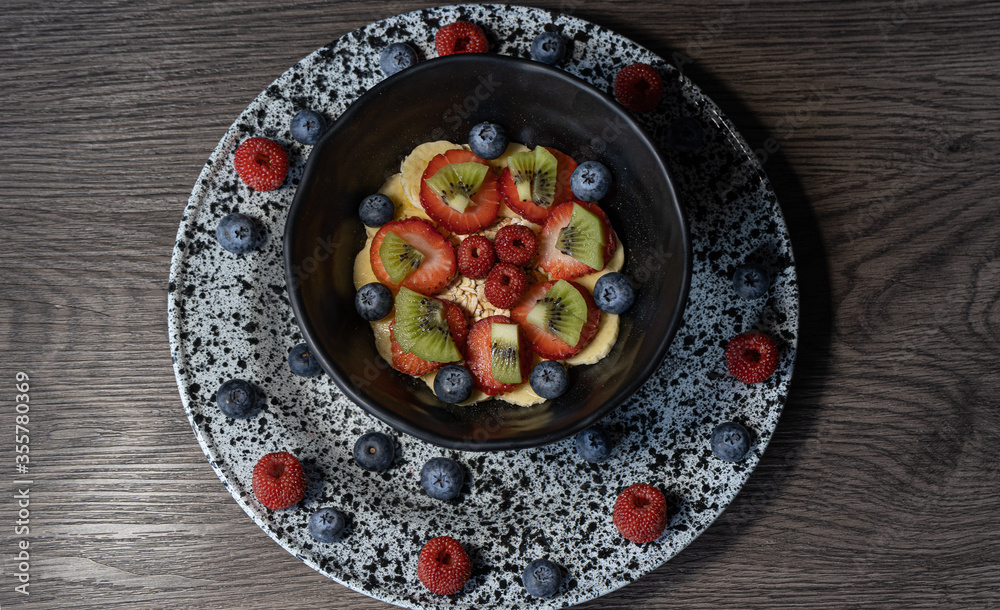 fruit plate with oats. dark food photography