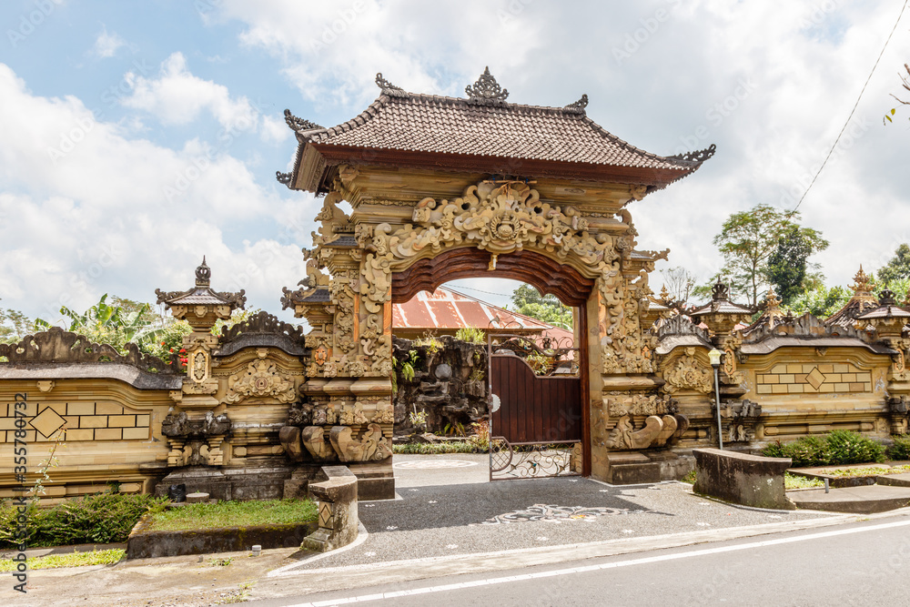 Fototapeta premium Entrance gate of a traditional Balinese house in Desa Katung in Kintamani, Bangli, Bali, Indonesia.