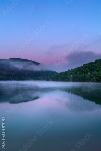 sunrise at a cold lake in misty morning waterland nature reserve belgium ardennes coo