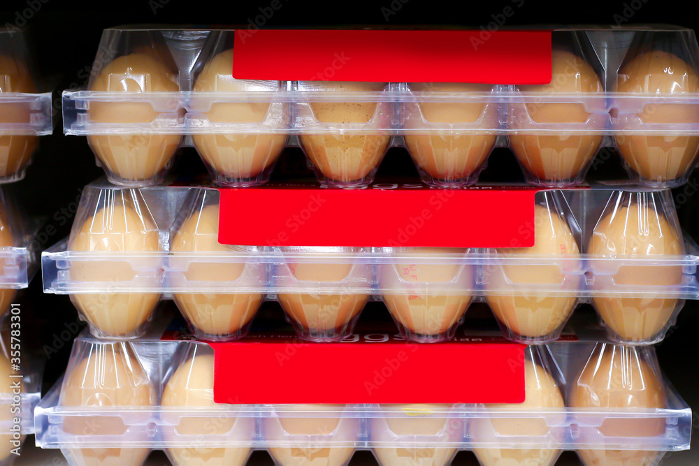 Chicken eggs in a transparent plastic tray on shelf in supermarket Chicken eggs in a transparent plastic tray on shelf in supermarket