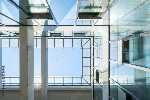 Looking up at the glass window of the office building
