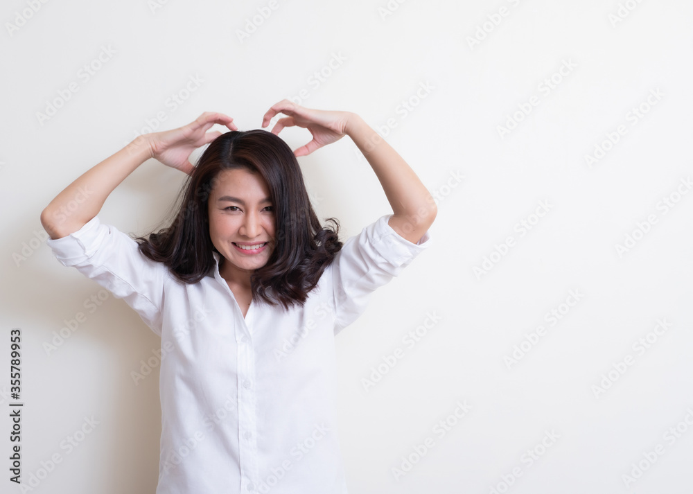 Portrait of young asian woman standing and smiling Portrait of young asian woman standing and smiling