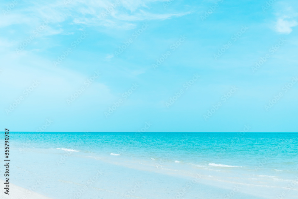 Fototapeta premium Tropical nature clean beach and white sand in summer with sun light blue sky and bokeh background.