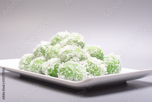 A set of traditional confectionery famous in Malaysia,Indonesia and Singapore,know as Buah Melaka or ondeh-ondeh ,isolated over grey,food photography concept 