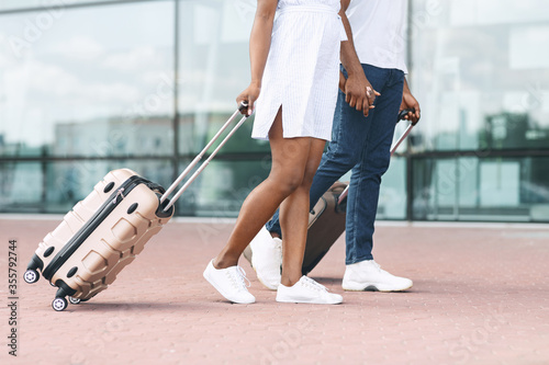 Going To Travel. Unrecognizable Couple Walking Near Airport Terminal With Suitcases