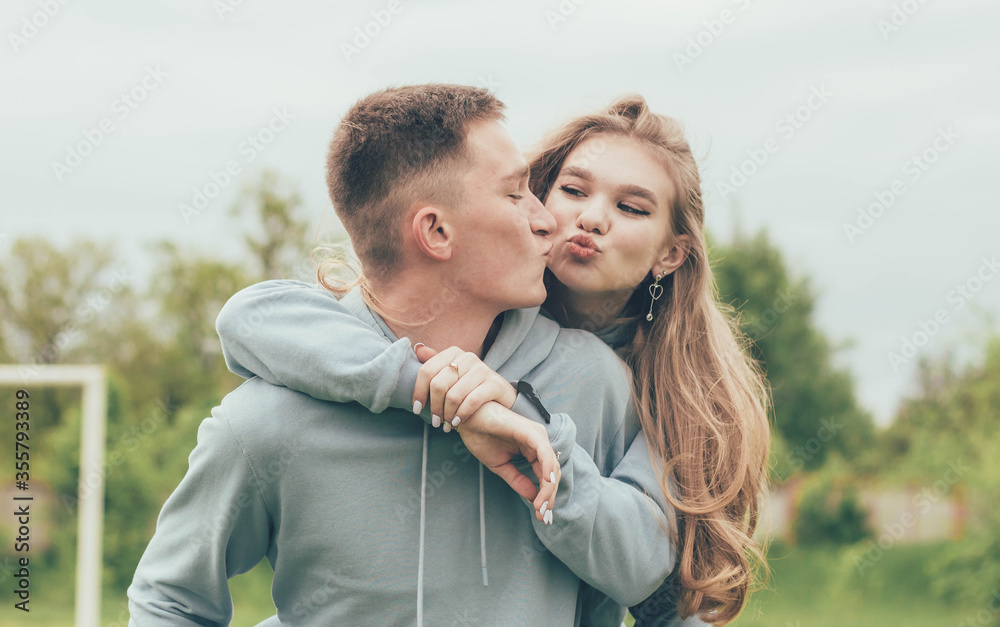 Fototapeta premium A girl sits on a guy's back,
