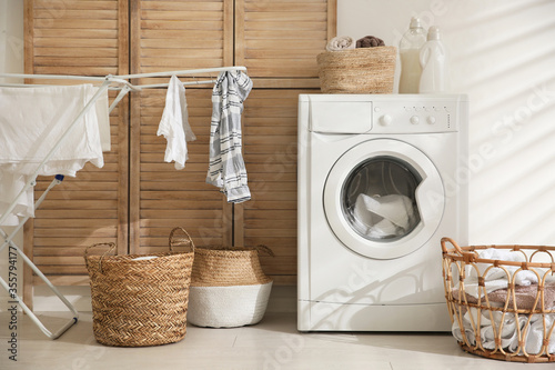 Modern washing machine in laundry room interior photo