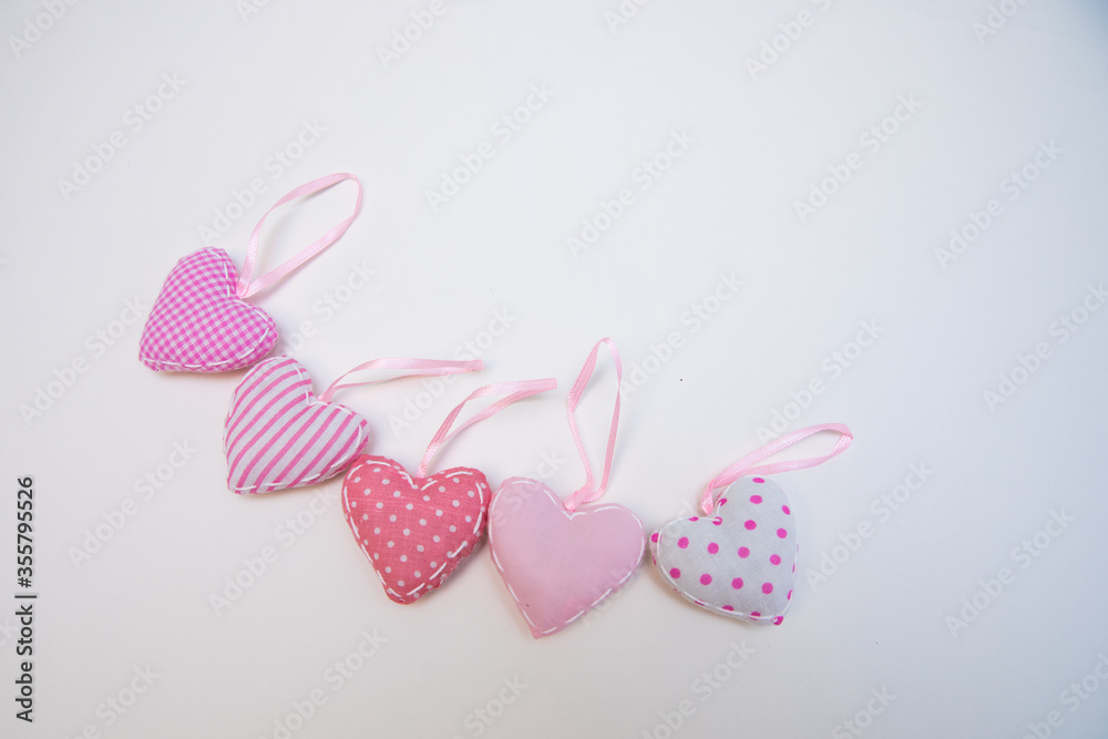 Lovely romantic pink heart-shaped hand sewing crafted decoration on a white background. Lovely romantic pink heart-shaped hand sewing crafted decoration on a white background.