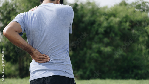 Obraz na plátne Sport man feeling backache outdoors