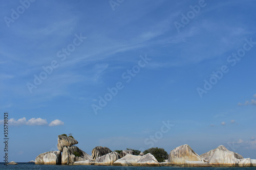 Blue crystal beaches surrounded by granit stones. Tanjung Kelayang Beach,Bangka Belitung island, Indonesia photo