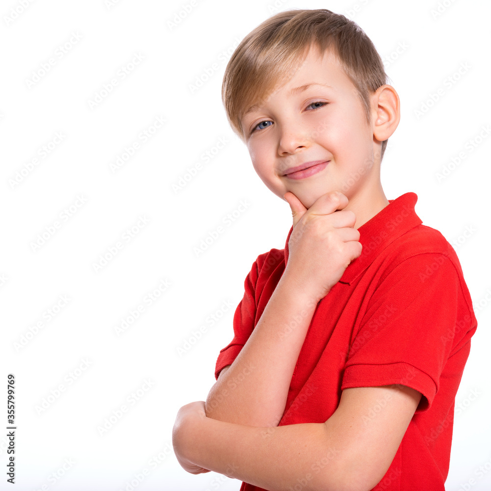 Portrait of white smiling kid in a red t-shirt looking away. Photo of a thinking boy looking at camera. Caucasian boy with a sly look, thinking about. Pretty kid with a easy smile Portrait of white smiling kid in a red t-shirt looking away. Photo of a thinking boy looking at camera. Caucasian boy with a sly look, thinking about. Pretty kid with a easy smile