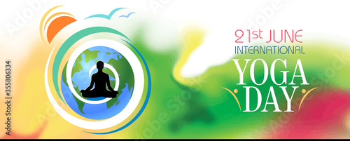 A silhouette of a person meditating on the international yoga day. Earth and the rising sun with colorful background