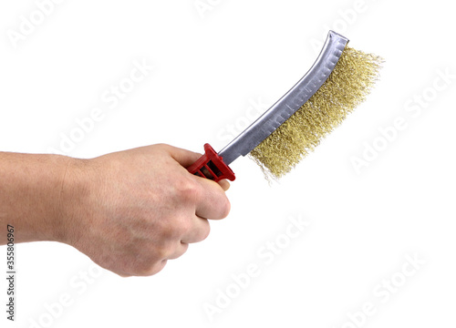 A man's hand with metal wire brush isolated. A hand holding a wire brush.Tools fof welding. Wire brush for cleaning